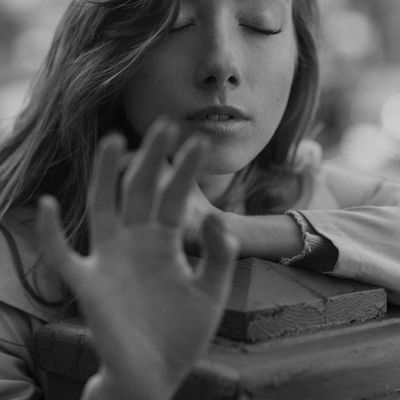 A person in a meditative pose with a calm and focused expression.